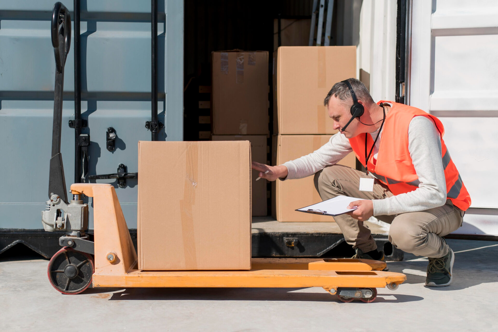 Person inspecting boxes on pallet.